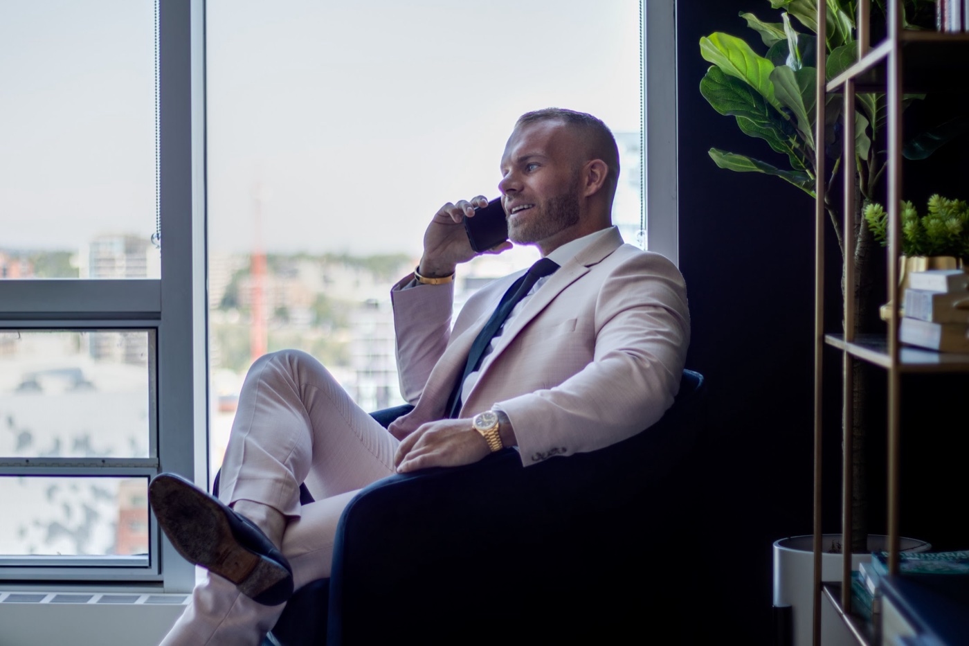 Spencer Rivers taking a client call in a Calgary high-rise